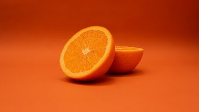 sliced lemon on orange surface