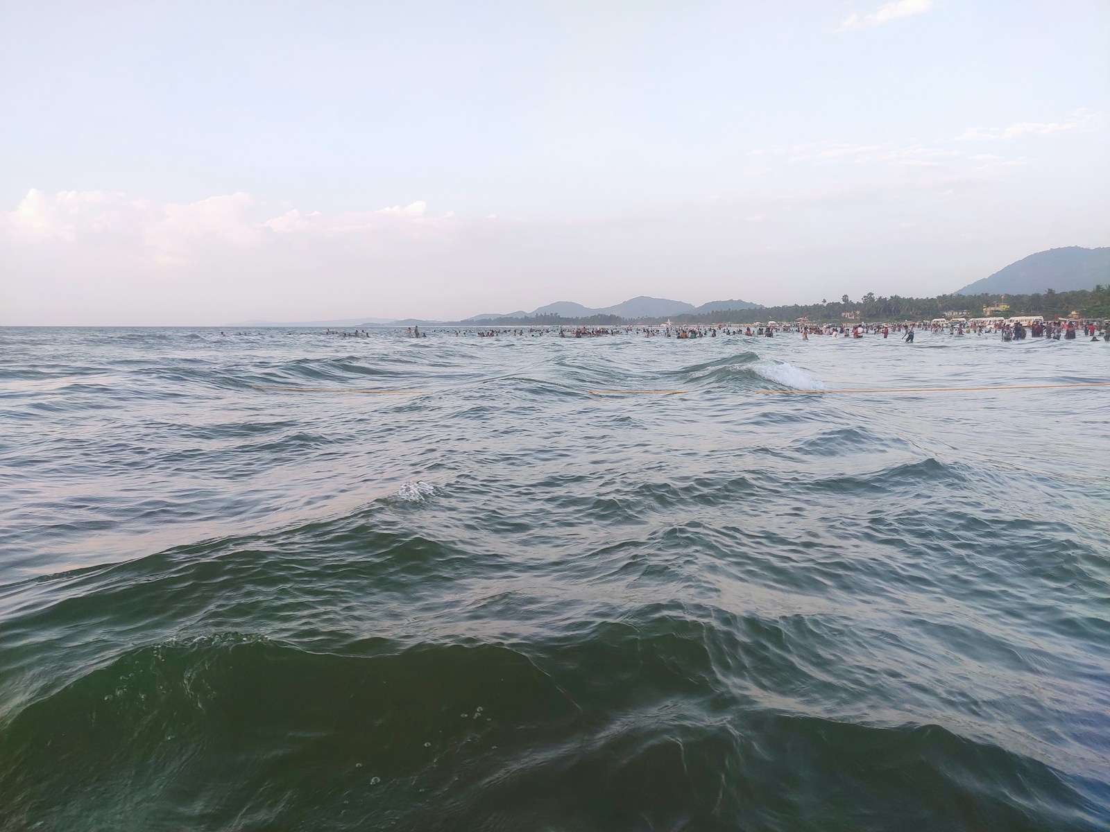 a large body of water with people in the distance