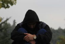 person in black hoodie and blue jacket