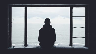 person looking out through window