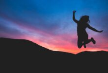 silhouette of person jumping during dawn