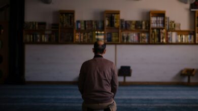a person standing in front of a bookshelf