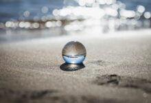 clear toy marble with reflection of seashore