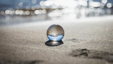 clear toy marble with reflection of seashore