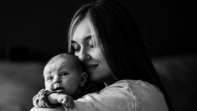 a woman holding a baby in her arms