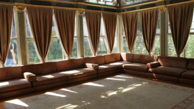 a living room with a couch and large windows