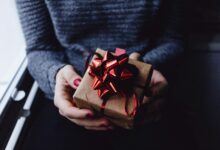 person holding present box