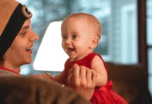 smiling woman holding a smiling child