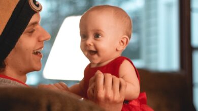 smiling woman holding a smiling child