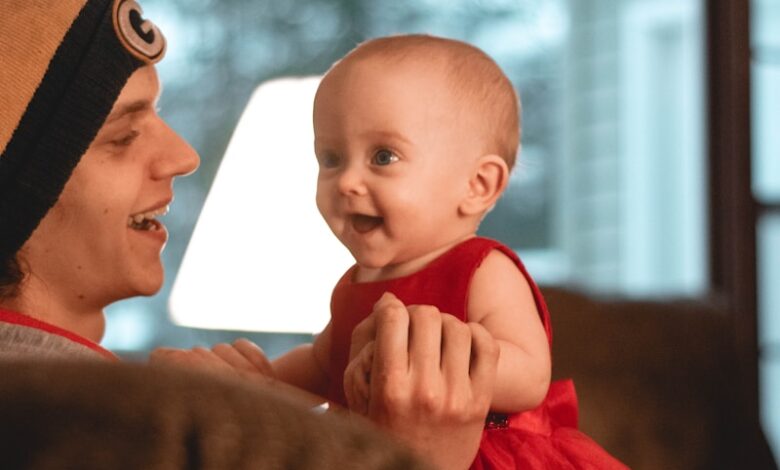 smiling woman holding a smiling child