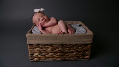baby lying on brown wicker basket